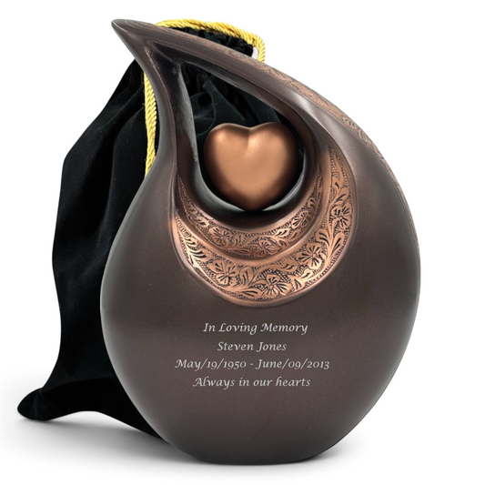Graceful Urns bronze teardrop cremation urn with floral engraving, heart centerpiece, and custom memorial inscription.